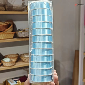 Packaged blue cake roll with a blurred kitchen background
