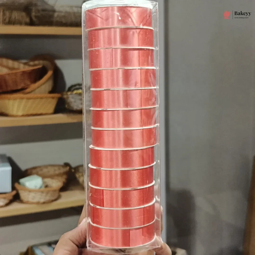 Pack of red baking cups held in front of a neutral background