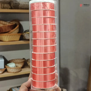 Pack of red baking cups held in front of a neutral background