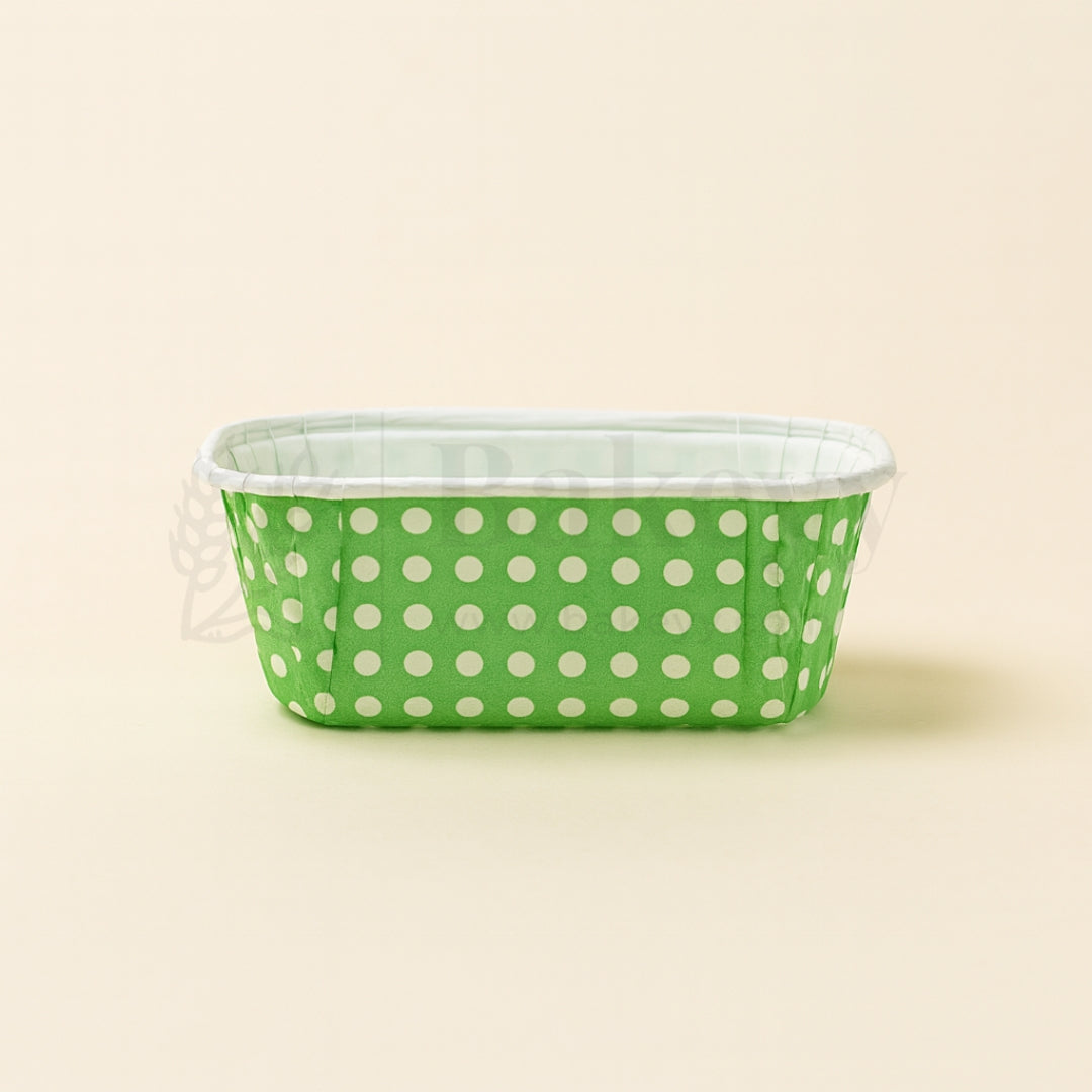 Green container with white polka dots on a beige background