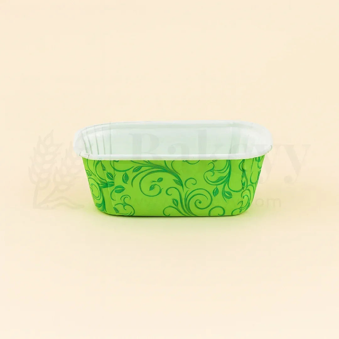 Green patterned container with white lid on a beige background