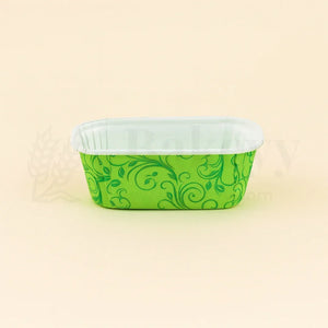 Green patterned container with white lid on a beige background