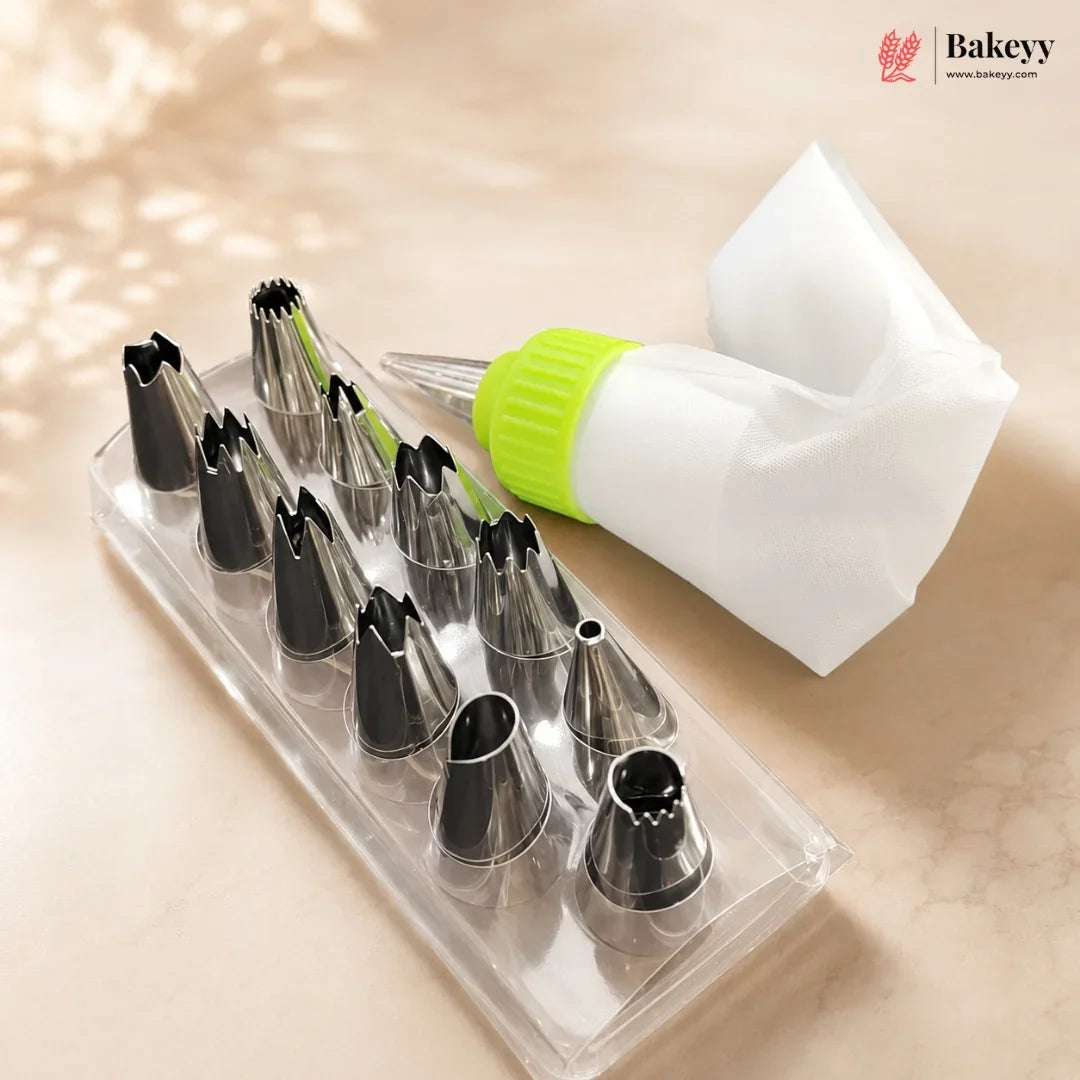 A set of 12 stainless steel piping nozzles in a clear plastic tray, a white piping bag with a bright green cap, and a folded white pastry bag, displayed on a beige marble surface with a soft shadow overlay. The Bakeey brand logo is visible in the top right corner.
