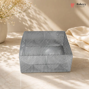 Decorative metal box with geometric pattern on a light surface, featuring the Bakeyy brand.