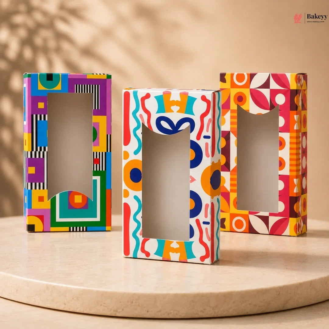 Three colorful letter-shaped boxes on a wooden surface with a beige background