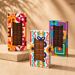 Three colorful chocolate bars in decorative boxes on a beige background