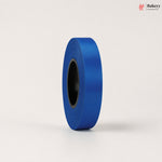 Roll of blue ribbon on a light gray background