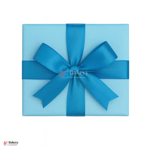Blue gift box with a large blue bow on a white background