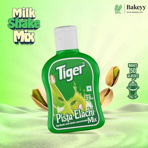 Green bottle of Tiger Pista Elachi Mix on a green background with 'Bakeyy' branding.
