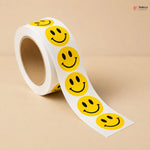 Roll of yellow smiley face stickers on a beige background