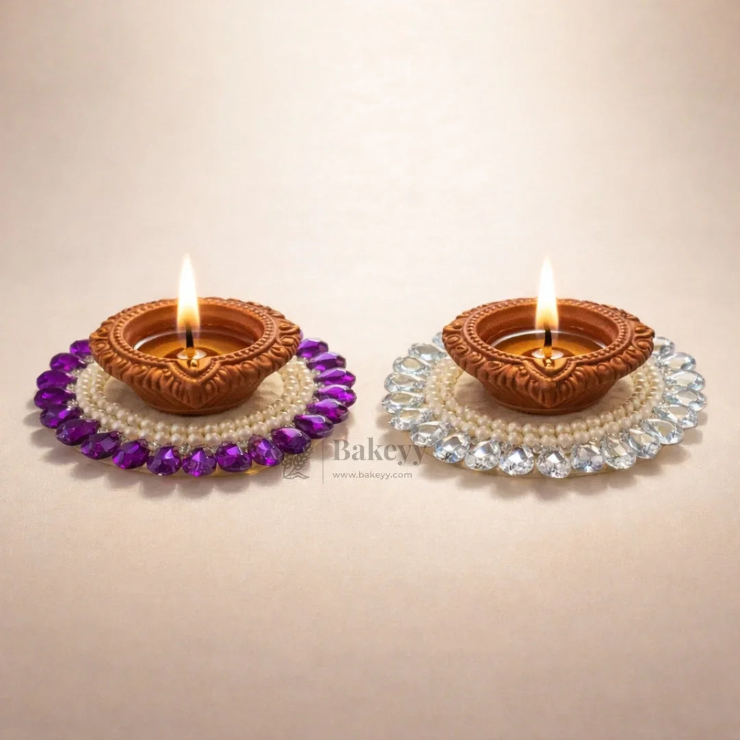 Decorative clay diyas with beads on Bakeyy.com, ideal for festive or gift decorations.