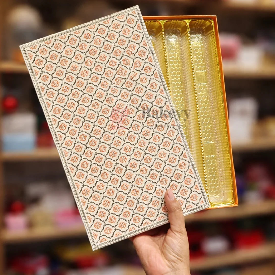 Capacity: Suitable for approx. 1 kg sweets or chocolates (depending on product type)
Premium rigid hardboard construction
Luxury floral printed lid design
Gold finish food-grade plastic inner tray
4 long compartments for organized arrangement
Ideal for Diwali, Weddings, Festive Hampers & Corporate Gifting