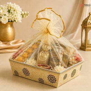 Decorative gift box with a bow, containing various items, on a beige background.