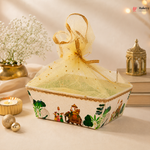 Decorative box with a sheer lid on a table with candles and flowers