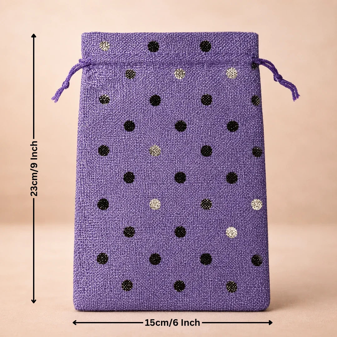 Purple drawstring bag with black and gold polka dots and measurements on a beige background