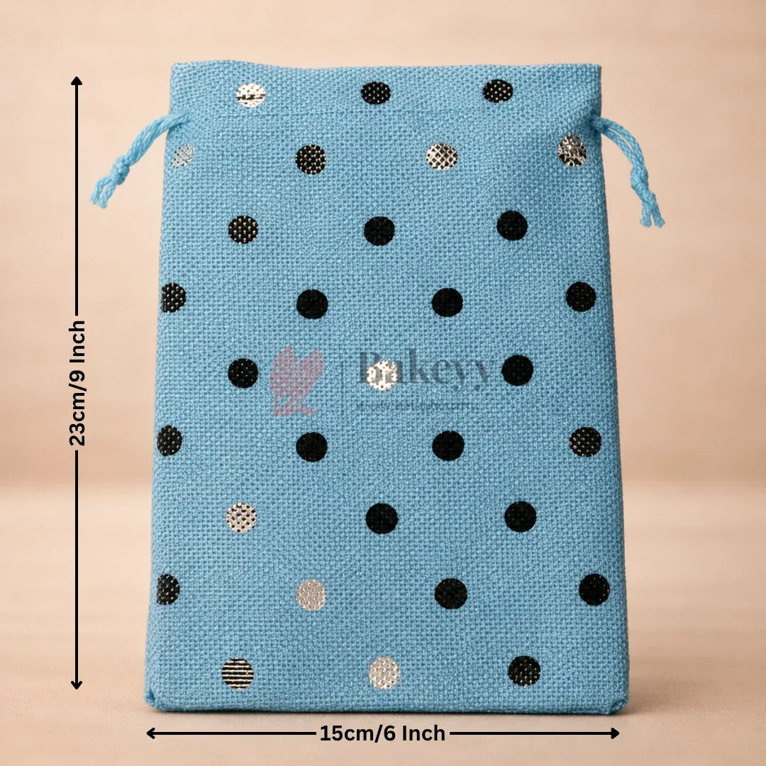 Blue drawstring bag with black and gold polka dots and measurements on a beige background