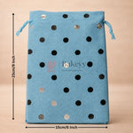 Blue drawstring bag with black and gold polka dots and measurements on a beige background