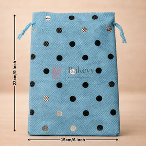 Blue drawstring bag with black and gold polka dots and measurements on a beige background