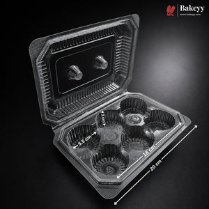A clear plastic cupcake container with six individual cupcake liners, shown open on a dark background with dimension annotations indicating 20 cm length, 10 cm width, and 4.5 cm liner height.