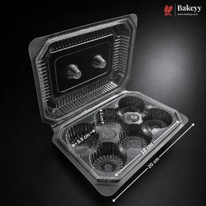 A clear plastic cupcake container with six individual cupcake liners, shown open on a dark background with dimension annotations indicating 20 cm length, 10 cm width, and 4.5 cm liner height.