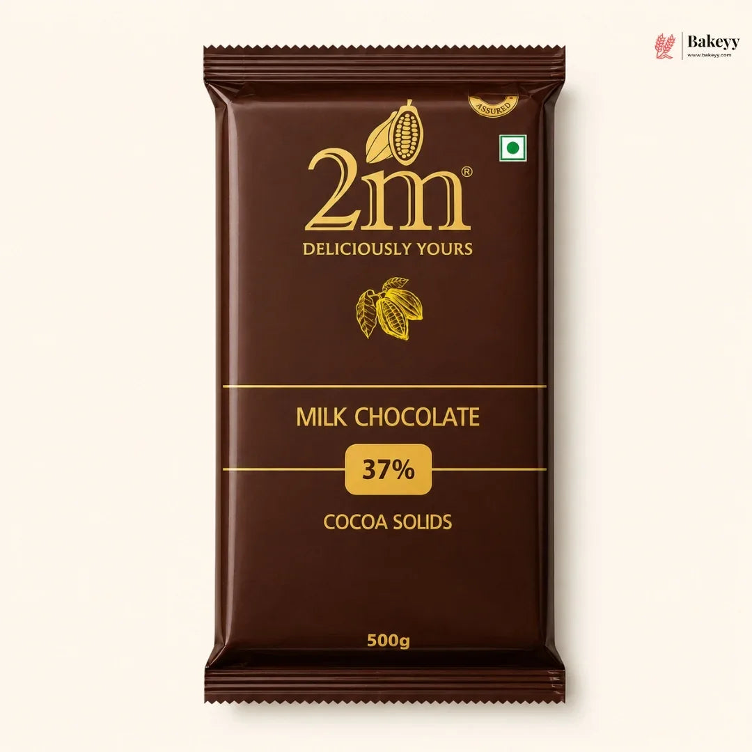 A 500g package of 2m Milk Chocolate 37% Cocoa Solids, shown against a light cream background. The packaging is dark brown with gold lettering and cocoa illustrations.