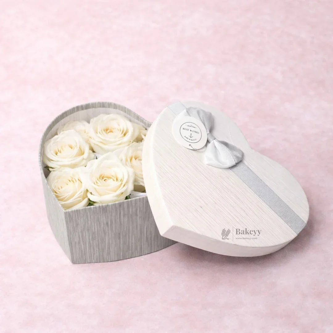 Heart-shaped white gift box with six white roses on pink background, Bakeyy gift packaging