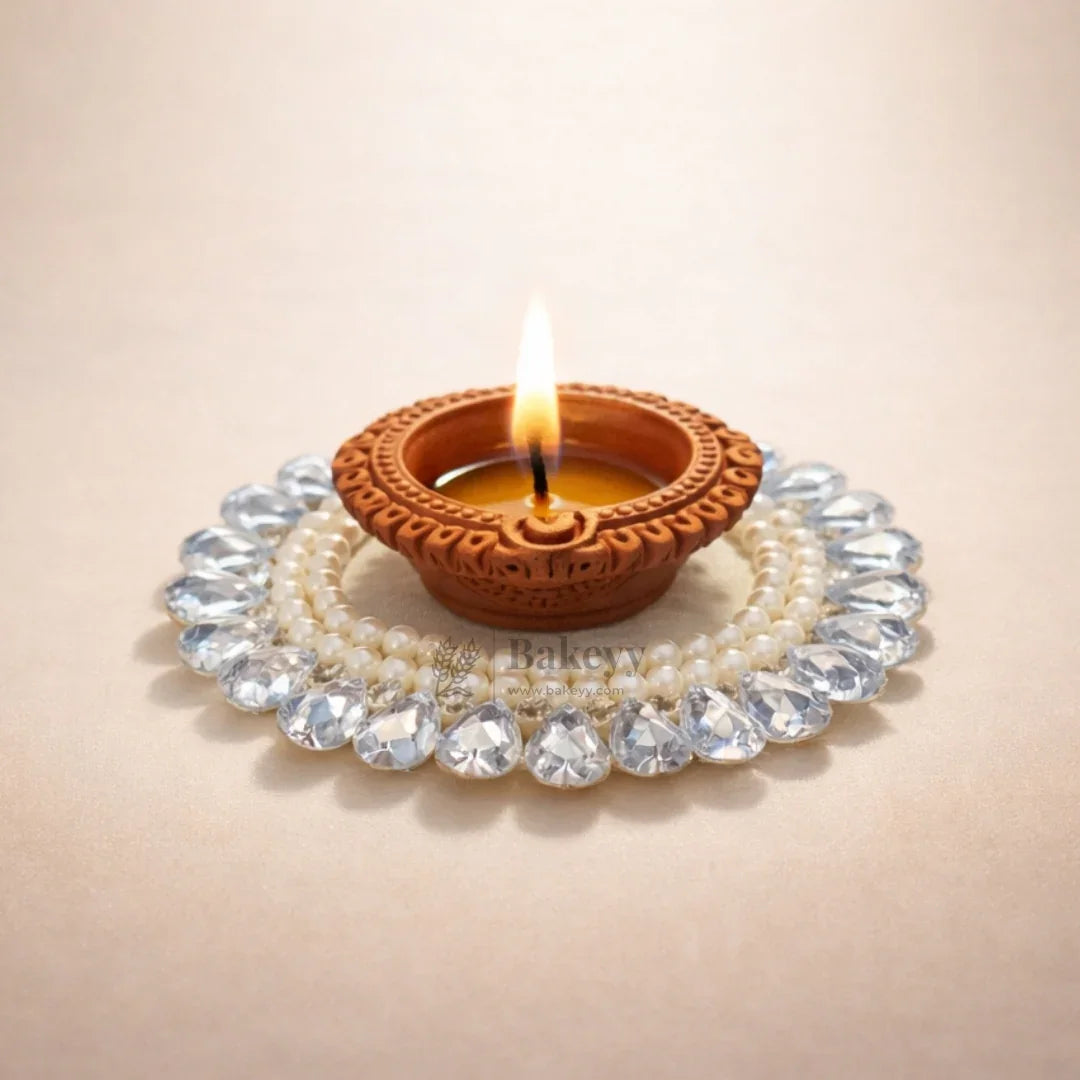 Decorative clay diya with pearls and crystals, festive décor from Bakeyy wholesale baking supplies.