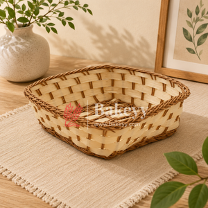 Woven basket on a table with a plant and framed picture in the background, featuring the Bakevvy brand.