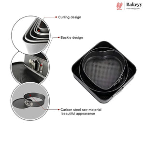 Black heart-shaped carbon steel springform cake pans shown with three circular detail callouts highlighting the curling design, buckle design, and raw material finish. The Bakeyy brand logo is visible in the top right corner.