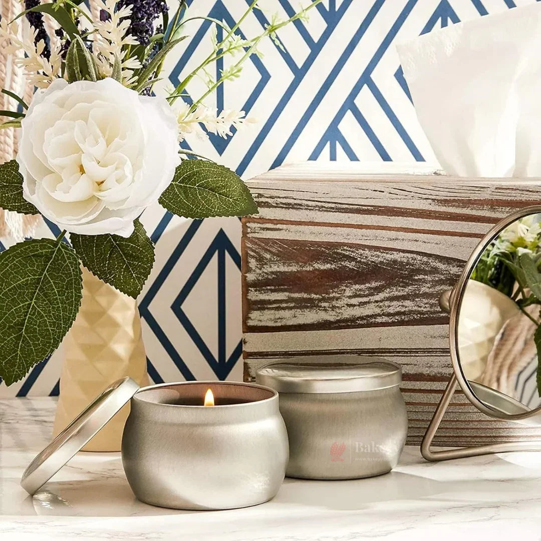 Silver tin scented candle and decor on marble surface, Bakeyy wholesale baking supplies.