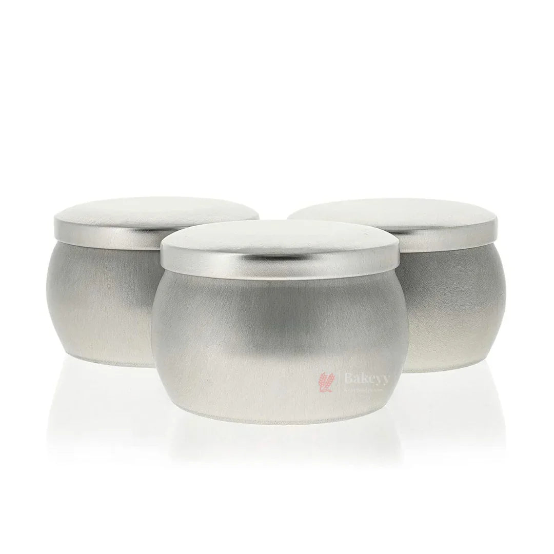 Set of three round metal storage tins with lids, ideal for bakery packaging from Bakeyy.com