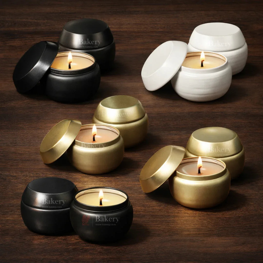 Assorted gift candles in black, white, and gold jars on a wooden surface, Bakeyy.com branding