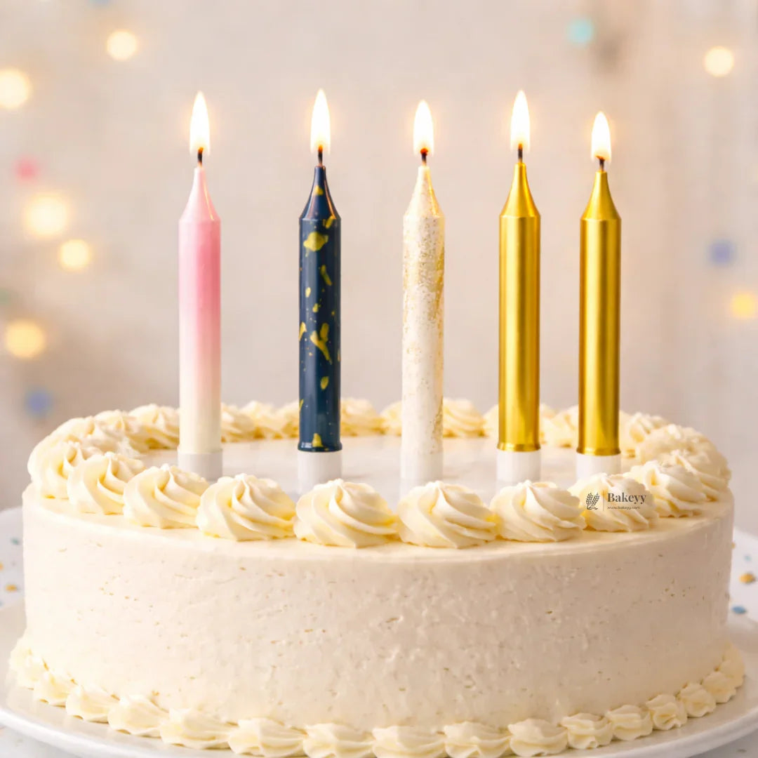 Birthday cake with white icing and five decorative candles from Bakeyy, perfect for celebrations