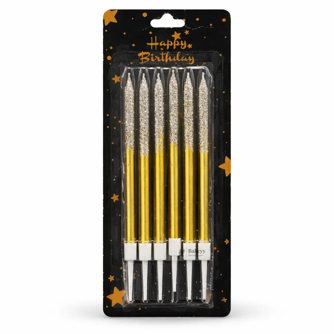 Pack of six gold glitter birthday candles in black star-themed Bakeyy packaging
