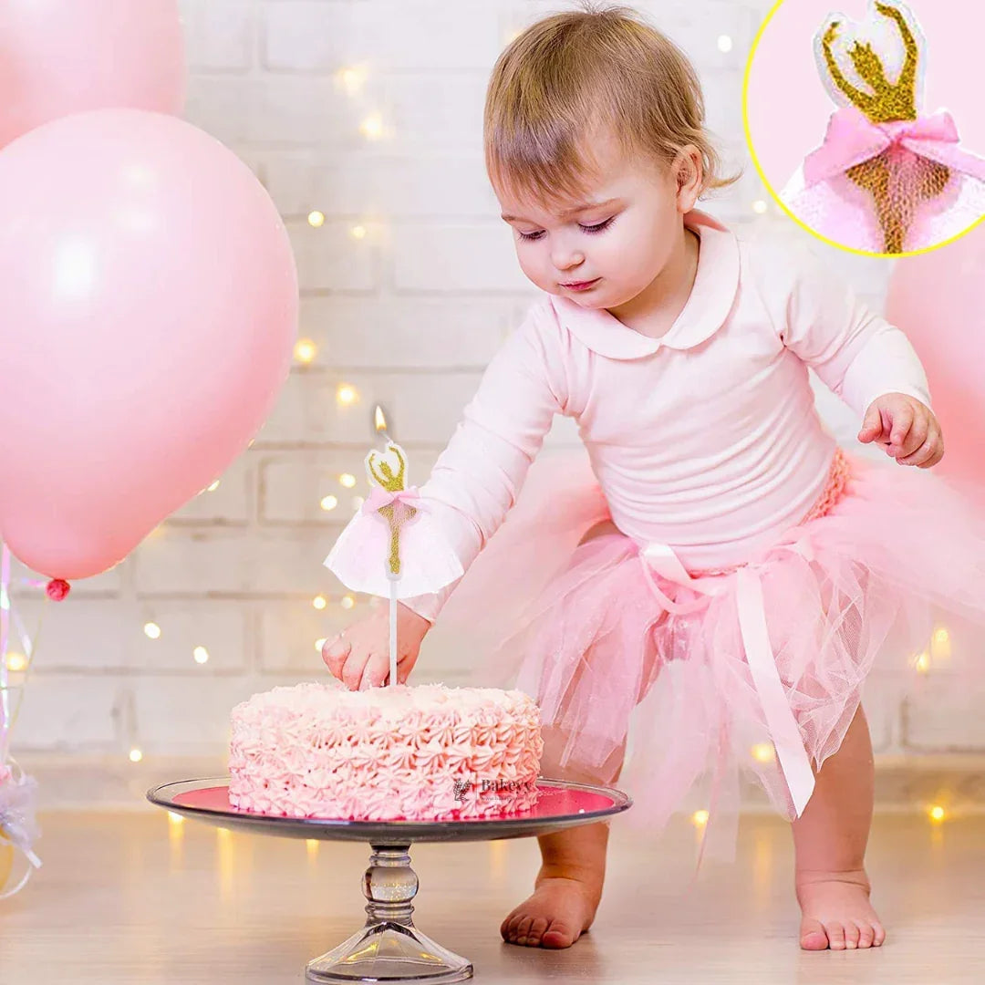 Baby in pink tutu at birthday party with ballerina cake and candle, pink balloons, Bakeyy.com baking supplies.