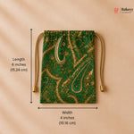 Green drawstring bag with gold paisley pattern and measurements on a beige background