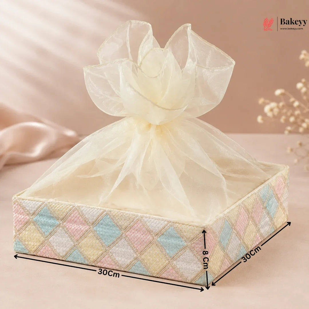 Decorative gift box with a sheer bow on a soft pink background, featuring dimensions.