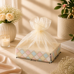 Decorative box with a bow on a table with flowers and candles