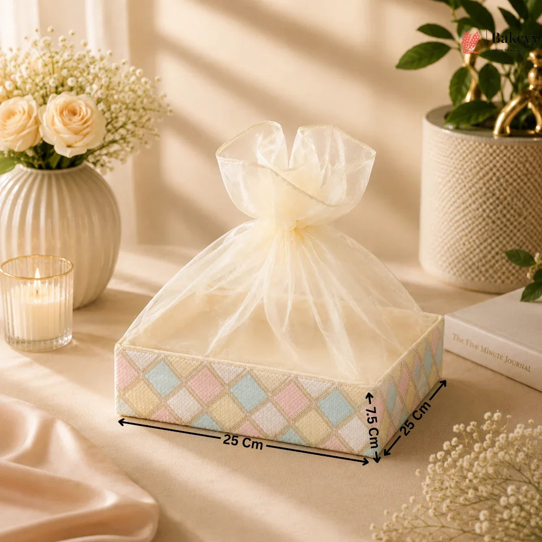 Decorative box with a bow on a table with flowers and candles
