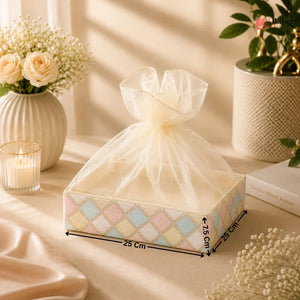 Decorative box with a bow on a table with flowers and candles