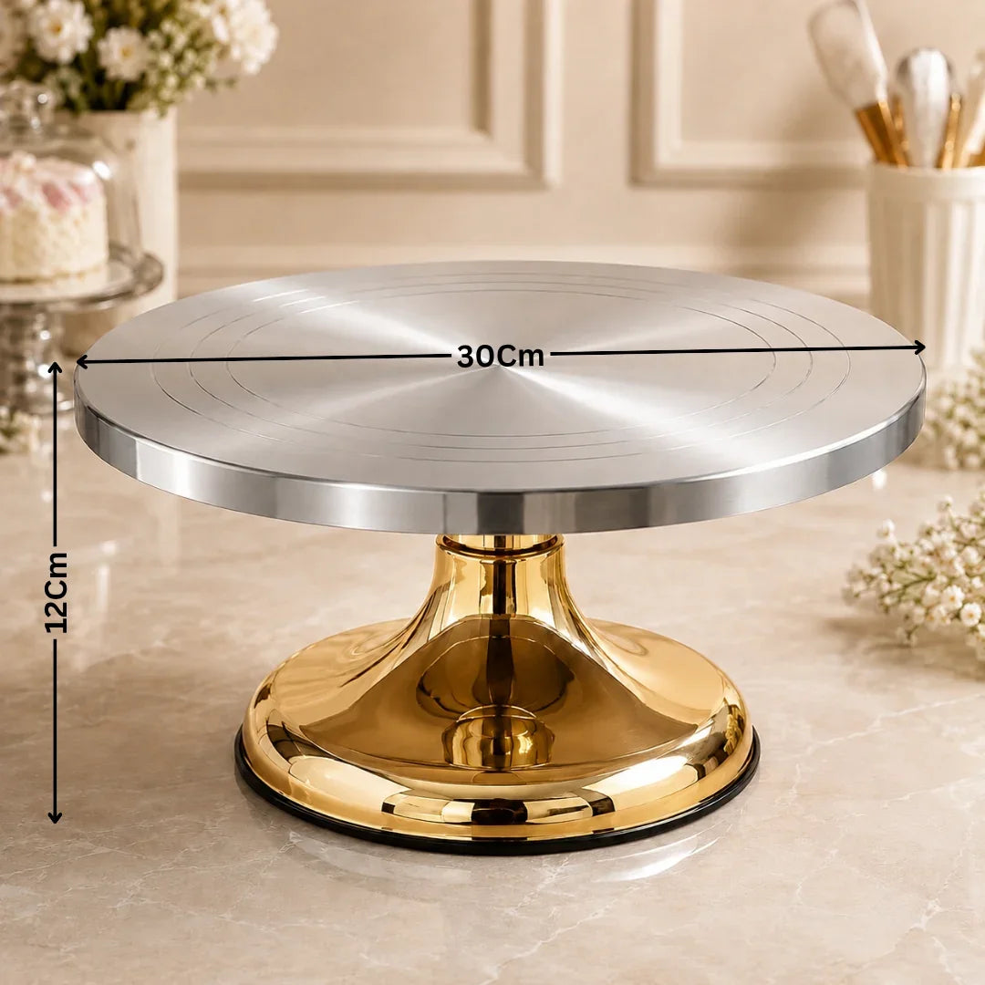 Silver cake stand with gold base on a marble surface, dimensions indicated.