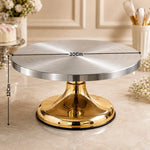 Silver cake stand with gold base on a marble surface, dimensions indicated.