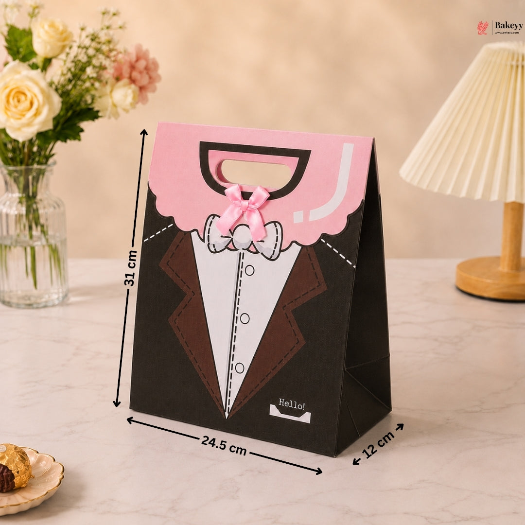 Gift bag with tuxedo design and dimensions on a table with flowers and lamp in the background