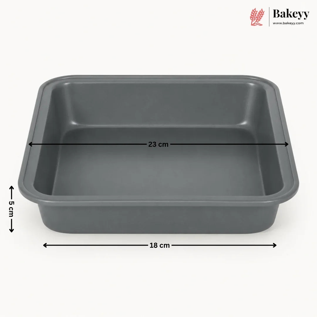 A dark gray rectangular baking pan with dimension lines indicating 33 cm length, 18 cm width, and 5 cm height, shown on a light gray background with the Bakeyy logo in the top right.
