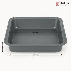 A dark gray rectangular baking pan with dimension lines indicating 33 cm length, 18 cm width, and 5 cm height, shown on a light gray background with the Bakeyy logo in the top right.