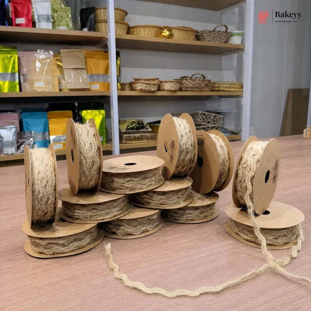 Spools of twine on a wooden surface with shelves in the background