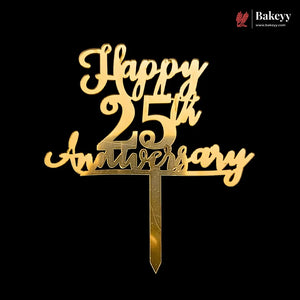 Gold-colored metal cake topper with 'Happy 25th Anniversary' script and number design, mounted on a pointed stake, shown against a solid black background. A Bakeyy brand logo is visible in the top right corner.