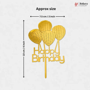 Gold-colored 'Happy Birthday' cake topper with balloon graphics, showing approximate dimensions of 10 cm in height and 7.5 cm in width, with a Bakeyy logo in the top right corner.