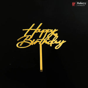 Gold metallic 'Happy Birthday' script cake topper on a black background, with a Bakeyy brand watermark in the top right corner.