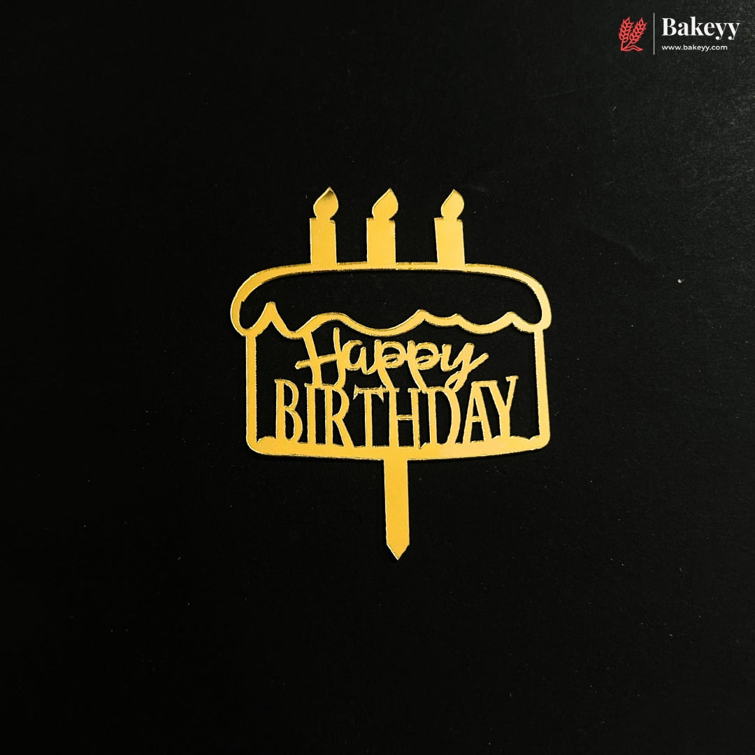 A gold metal cake topper with 'Happy Birthday' written on it, displayed on a black background with a Bakeey brand logo in the top right corner.